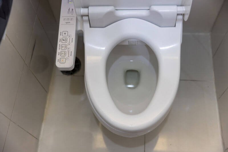 A smart toilet with control buttons on the side